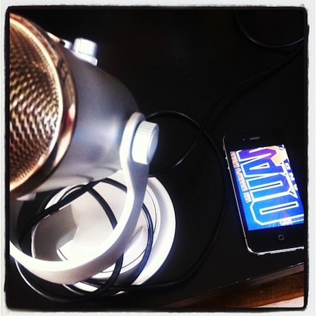 Still life photograph of a microphone and an iPhone.