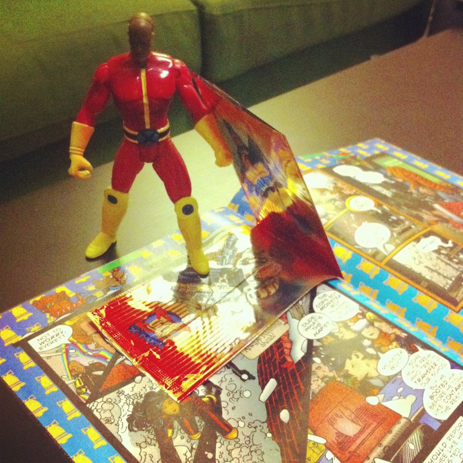 action figure standing on open comic book